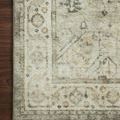 Close vertical crop highlighting corner design and subtly faded pattern of rug on dark floor