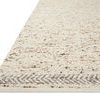 Side angled view showing low pile thickness and a soft textured surface with chevron border design