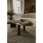 Styled room with Excelsior sofa alongside round coffee table and leather chairs, bright daylight