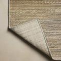 Corner edge flipped over to reveal the rug’s textured backing and edge binding