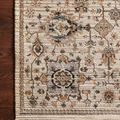 Leigh Ivory Taupe Rug with intricate traditional motifs in beige, taupe, blue, and orange tones on a textured polyester pile