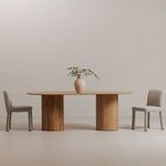 Place dining chairs styled in minimal room setting with wooden table and decorative vase