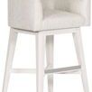 Side angle view showing thick cushioned upholstery and metal footrest on swivel base stool
