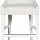Cove Stool with white wood frame, gently sloped back, and textured white upholstery, designed for bar or counter height