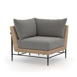 Front three-quarter angle with lighter gray cushions on woven rattan frame with metal legs