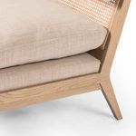 Close-up of Kenzo Chair seat and frame joint showing wood grain detail and cushion edges