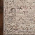 Low-angle side view highlighting rug’s thin profile and the soft muted border pattern
