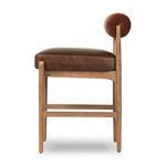 Side profile of Jazelle Havana Brown Counter Stool emphasizing cylindrical velvet backrest and leather seat