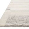 Low-angle close-up showing textured edges and woven details of the Evelina Ivory Beige Rug