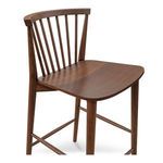 Close-up showing wood grain texture and craftsmanship of walnut counter stool seat and legs