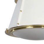 macro shot of brass rivets securing white tapered shade on the ceiling fixture