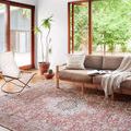 Wynter rug styled in a bright living room with modern furniture and large windows showing full rug placement