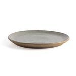 Single plate on white background seen from side, highlighting shallow depth and earthen speckled glaze