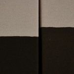 Close-up showing fine texture difference on beige and near-black fabric edges of canvases