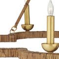 Close-up focusing on gold leaf candle holder and textured rattan wrapping along frame