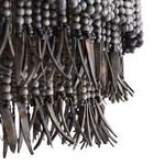 Macro view of coconut shell talons hanging from wood bead strands, showing natural texture and shape