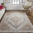 Percy Terracotta/Country Blue Rug styled in living room with white couch, wood floor, and rattan chair