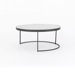 Large round coffee table with white marble top shown alone from side