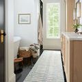 Chris Ivory Denim Rug as a long hallway runner with black tile floor and light wood cabinetry