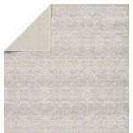 Back side of the rug folded over revealing solid neutral backing fabric