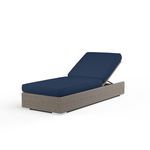 Adjustable outdoor chaise with driftwood resin wicker frame and navy blue plush cushions