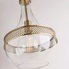 Angled shot showing pendant hanging with visible chain and glowing bulb inside the glass shade