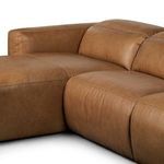 Close-up of corner junction between chaise and sofa seat showing leather texture and stitching
