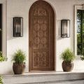 Black-finished version of Royster Outdoor Wall Sconce mounted beside carved wooden arched door