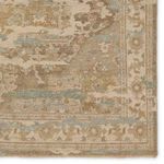 Detailed view of rug corner showing intricate medallion border pattern and soft color transitions.