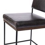 Close-up of Benton Stool seat corner showing black leather texture and wooden decking detail