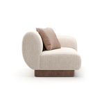 Side profile showing the curved armrest’s ribbed linen texture and single camel cushion