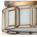 Side close-up showing textured white milk glass panels with antique brass metal framing
