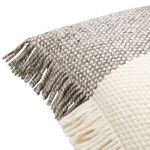 Close-up of corner showing twisted tassels and thick woven texture in cream and gray