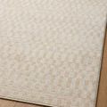 Kamala rug sample flat lay focusing on edge and Moroccan-inspired pattern on wood surface