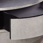 Partial view of open drawer showing interior black surface and light faux fur drawer front