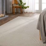 Side angle of cream rug in bedroom showing textured concentric pattern by bed and wooden chair