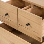 Open drawers showing full light wood interiors and black metal knobs on front panels