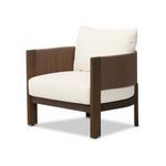 Three-quarter view showing the chair’s curved cording back and solid wood legs