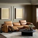 Radley sectional styled in warm living room with art on olive walls and coffee table in front