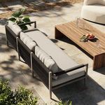 Overhead outdoor setting with sofa paired beside wooden coffee table on stone patio