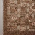 Close-up top-down view revealing detailed pattern variations and flat weave on concrete floor.