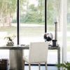 Linea side chair at marble and concrete console table with flower arrangement and wicker basket below