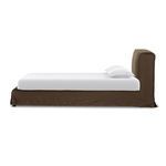 Side view of queen bed with brown linen slipcover, white mattress, and pillows