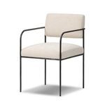 Fenn Dining Chair shown in three-quarter view highlighting curved armrests and cushioned seat