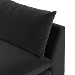 Close-up side angle of sofa with pillow and seat cushion corner, showing fabric detail