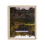 Vertical grain white oak framed photograph showing a dark rustic house reflected in a pond with floating lily pads