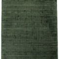 Soft green area rug with subtle tonal triangle pattern and smooth hand-carved texture