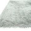 Close-up angled view showing the thick pile and detailed softness of the platinum shag rug's fibers
