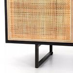 Close-up of cane weave and black metal base leg of Carmel Cane Sideboard