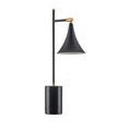 Lamp casting warm light downward through black fluted shade
